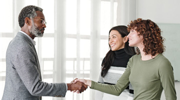 Woman shaking hands with taller man